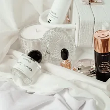 white and brown plastic bottle on white textile related to Ultimate Guide to Choosing the Perfect Bed Bath and Beyond Makeup Vanity