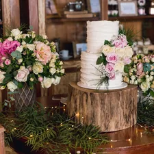 white and pink flowers on brown wooden round table related to Bring Rustic Charm to Your Home: Mastering the Art of Country Style Curtains and Valances