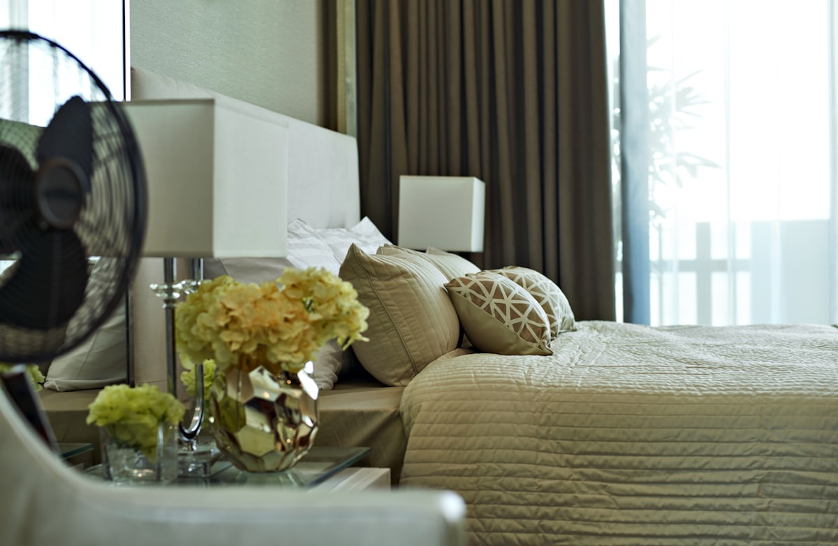 white and yellow flowers on clear glass vase on table related to Pleated Bed Valance and Bedroom
