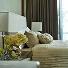white and yellow flowers on clear glass vase on table related to Pleated Bed Valance and Bedroom
