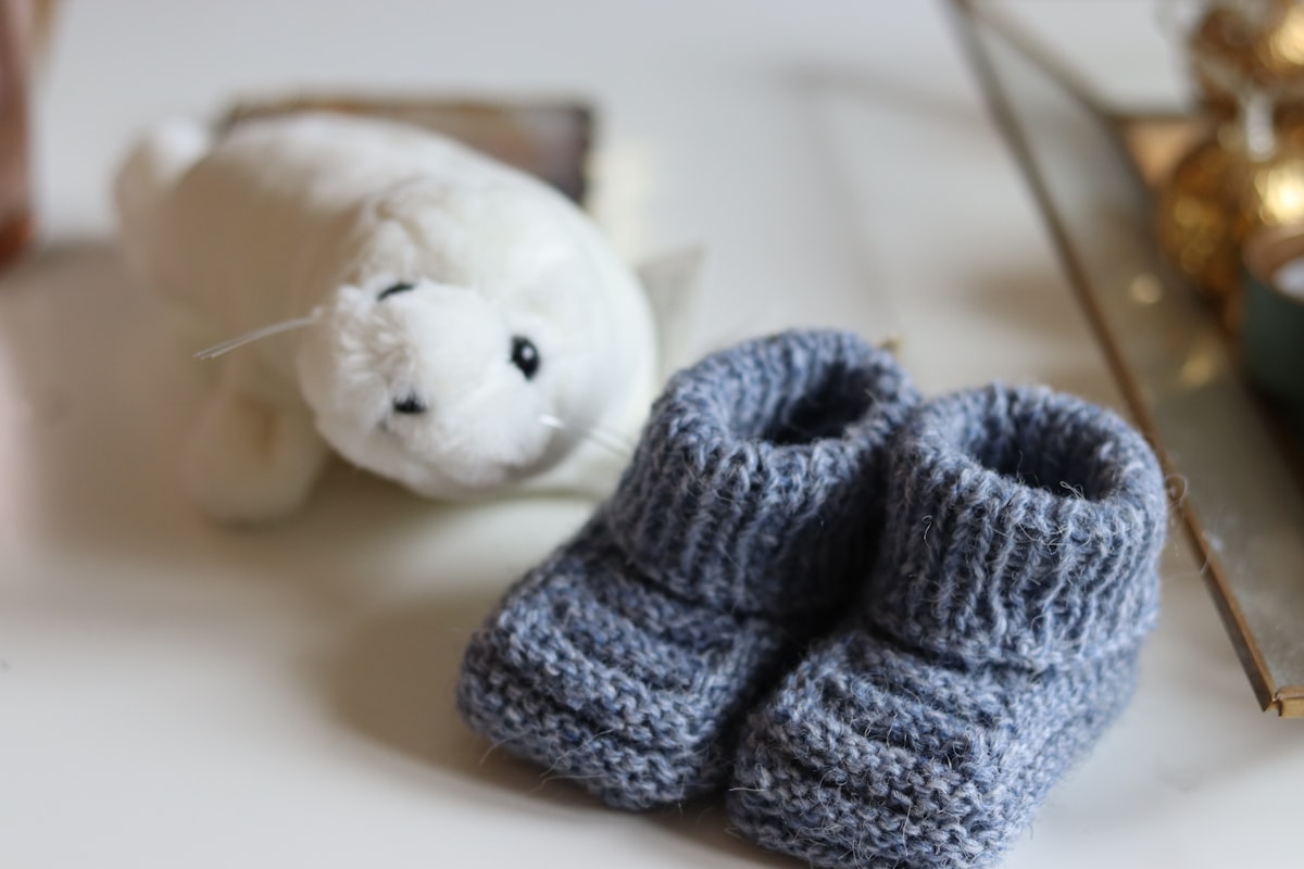 white bear plush toy on white table related to Cozy Comforts for Dolls: The Little Tikes Doll Bed Experience