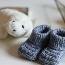 white bear plush toy on white table related to Cozy Comforts for Dolls: The Little Tikes Doll Bed Experience