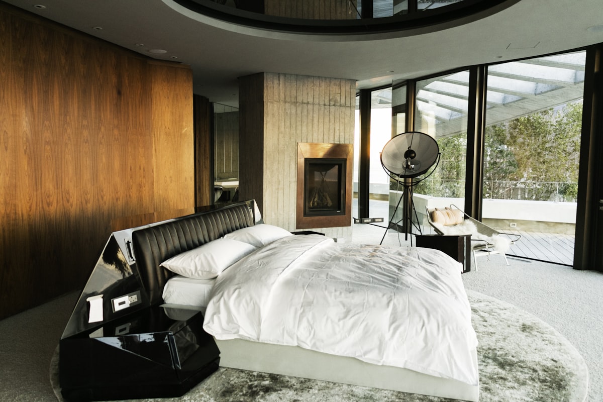 white bed linen near black table lamp related to The Rise of the Disc O Bed: A Sleeping Revolution