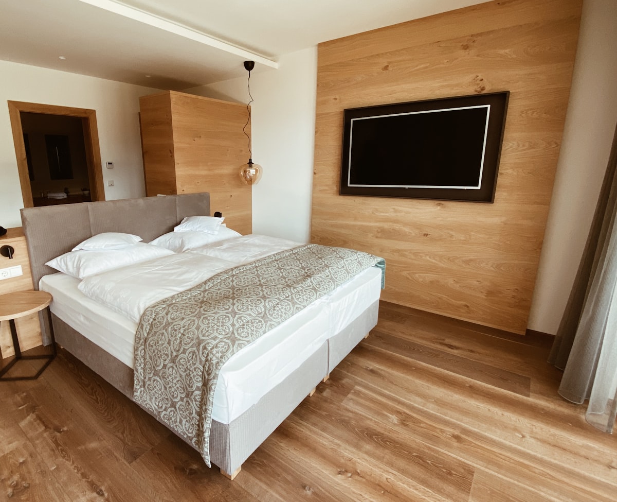 white bed linen on bed related to The Ultimate Sleep and Entertainment Experience: Beds with TVs