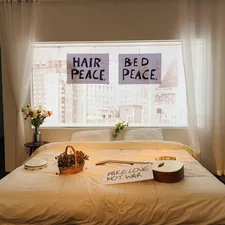 white bed linen with brown wooden table and chairs related to Rise and Shine: The Story of Bed Head Resurrection