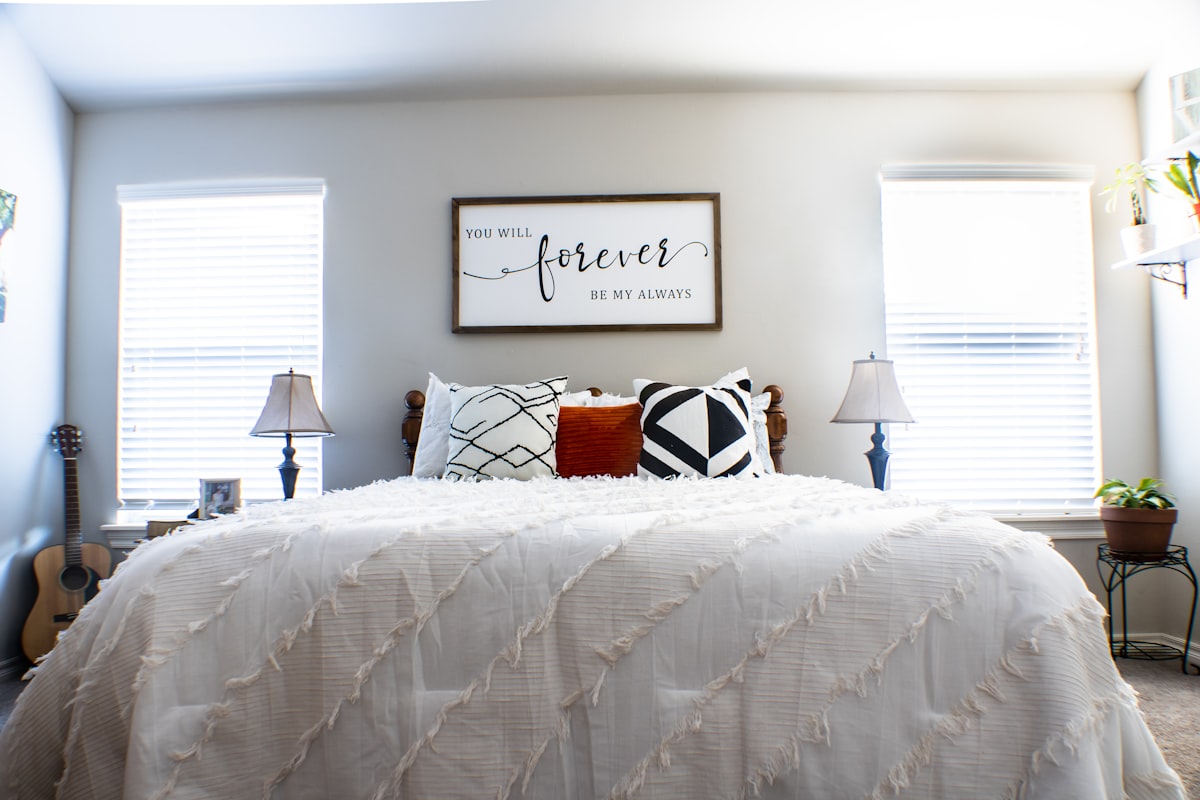 white bed linen with pillows and red table lamp related to Elevate Your Bedroom Style with a Matelasse Twin Coverlet