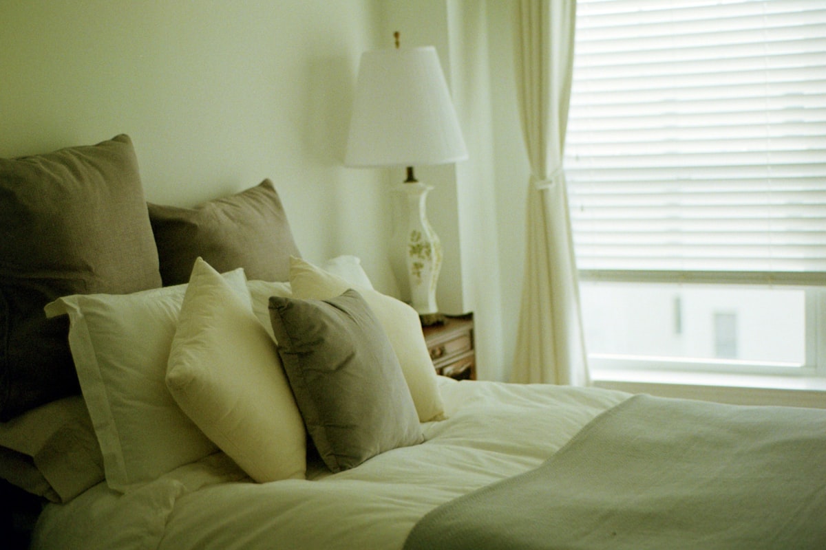 white bed pillow on bed related to Transforming Your Home with Bed Bath & Beyond Blinds