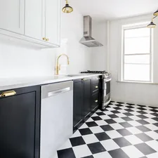 White & Black kitchen with gold faucets and gold finishings. Black & white checkered floor. Marble countertop. Black kitchen cabinets. White kitchen cabinets.  related to Exploring the Beauty of Patterns for Kitchen Valances
