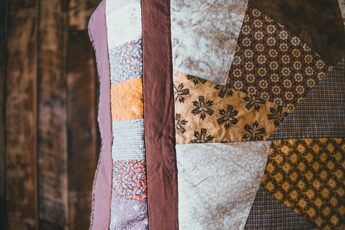 white blue and brown textile related to Quilt vs Coverlet: What's the Difference?