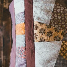 white blue and brown textile related to Quilt vs Coverlet: What's the Difference?