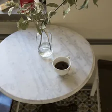 white ceramic mug on white round table related to Creating a Lasting First Impression: Marble Entryway Tables