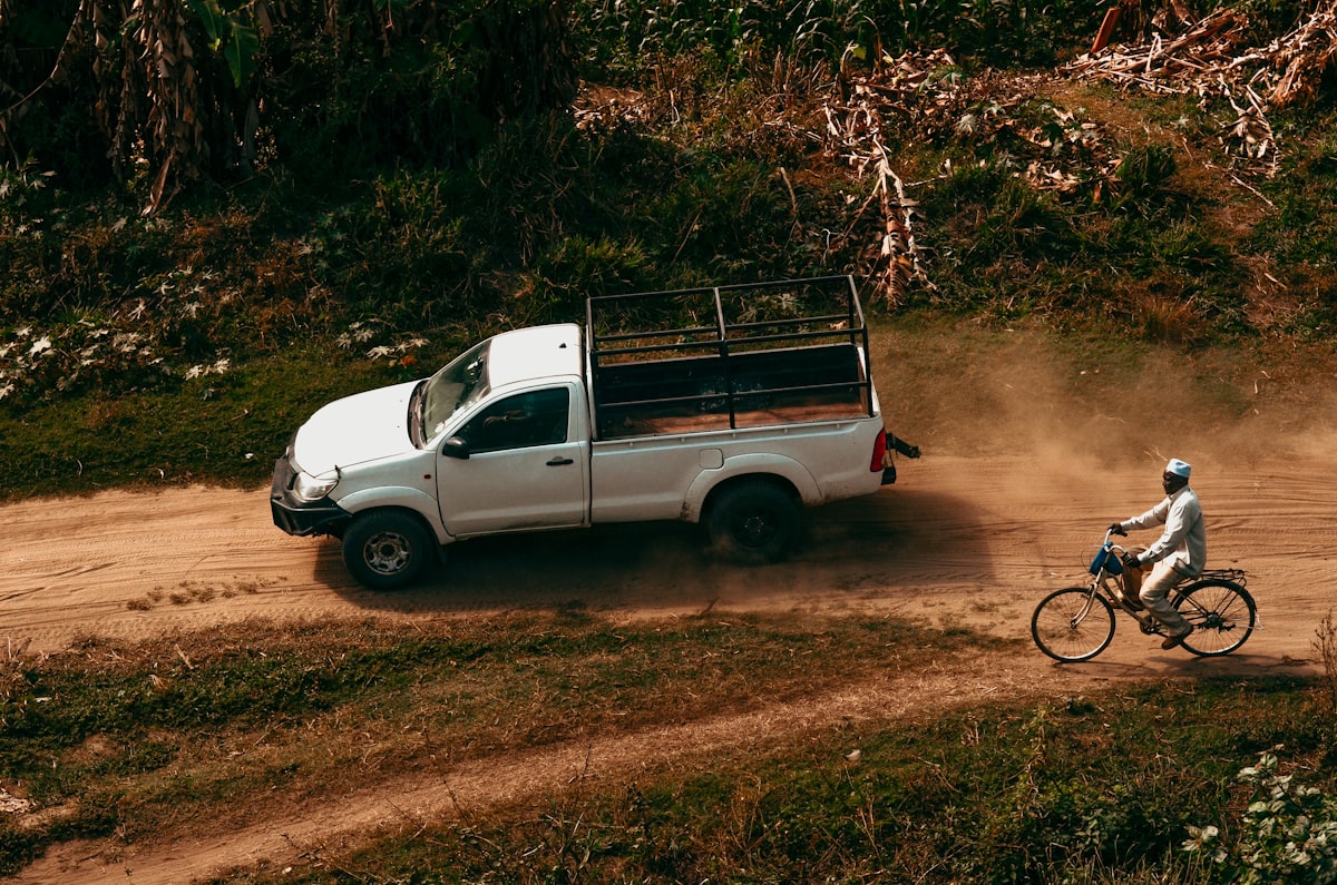 white crew cab pickup truck on dirt road related to Elevate Your Ride: The Ultimate Guide to Truck Bed Decks