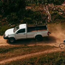 white crew cab pickup truck on dirt road related to Elevate Your Ride: The Ultimate Guide to Truck Bed Decks