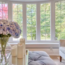white roses in clear glass vase on table related to Transform Your Windows with Custom Made Valances
