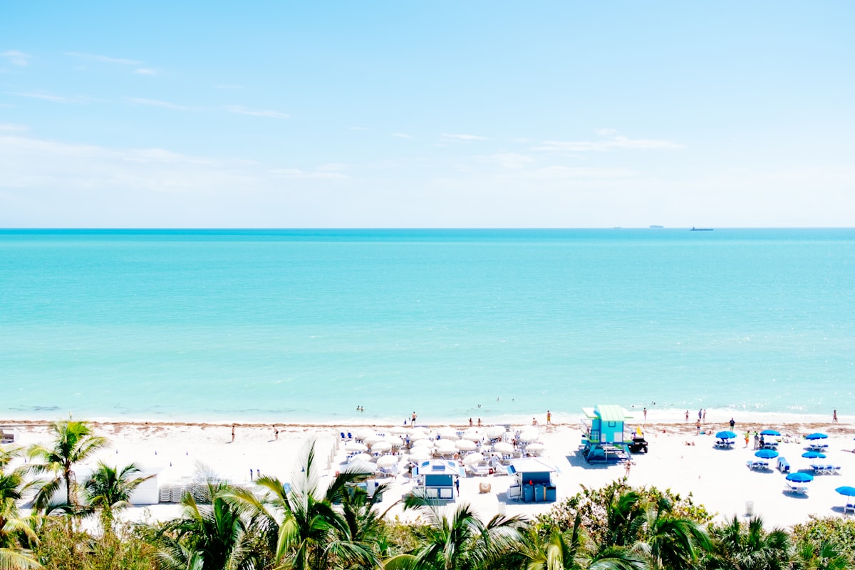 white sand beach with stalls under blue sky related to Discover the Charm of Miami's Bed and Breakfast
