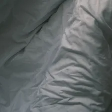 white textile on black textile related to Coverlet vs Duvet: What's the Difference?