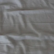 white textile on brown wooden table related to Light Grey Coverlets
