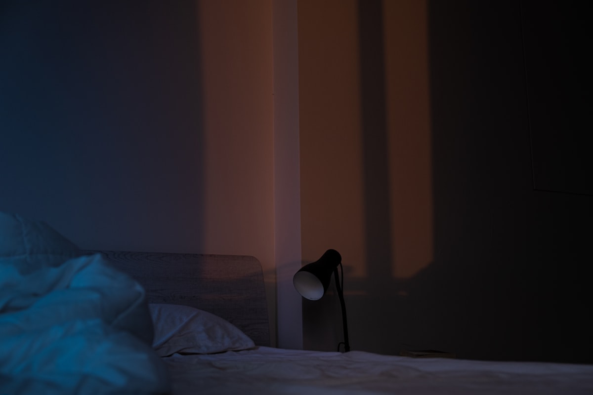 white textile on white bed related to Maximize Your Comfort: The Ultimate Guide to Clip-On Bed Lamps