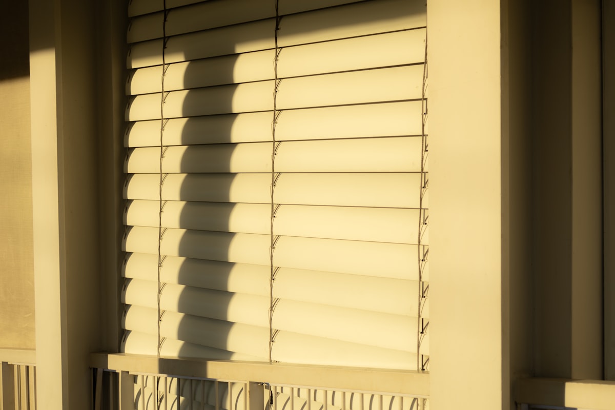 Window blinds cast shadows in the sunlight. related to Mastering Valance Window Treatments: A Guide to Measuring Like a Pro