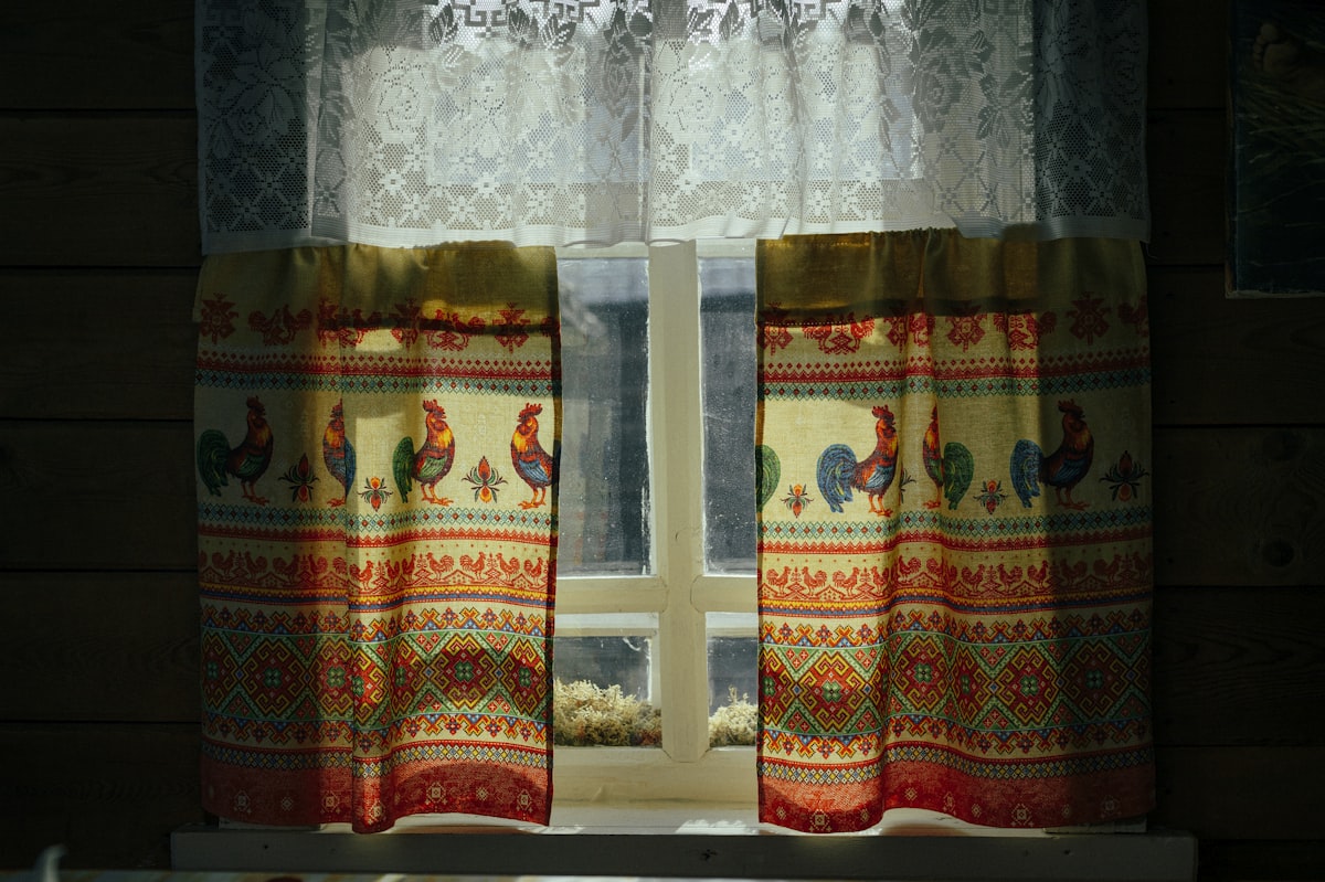 Window with national embroidered curtains in an old Russian house. related to Enhancing Window Décor with Valances and Swags