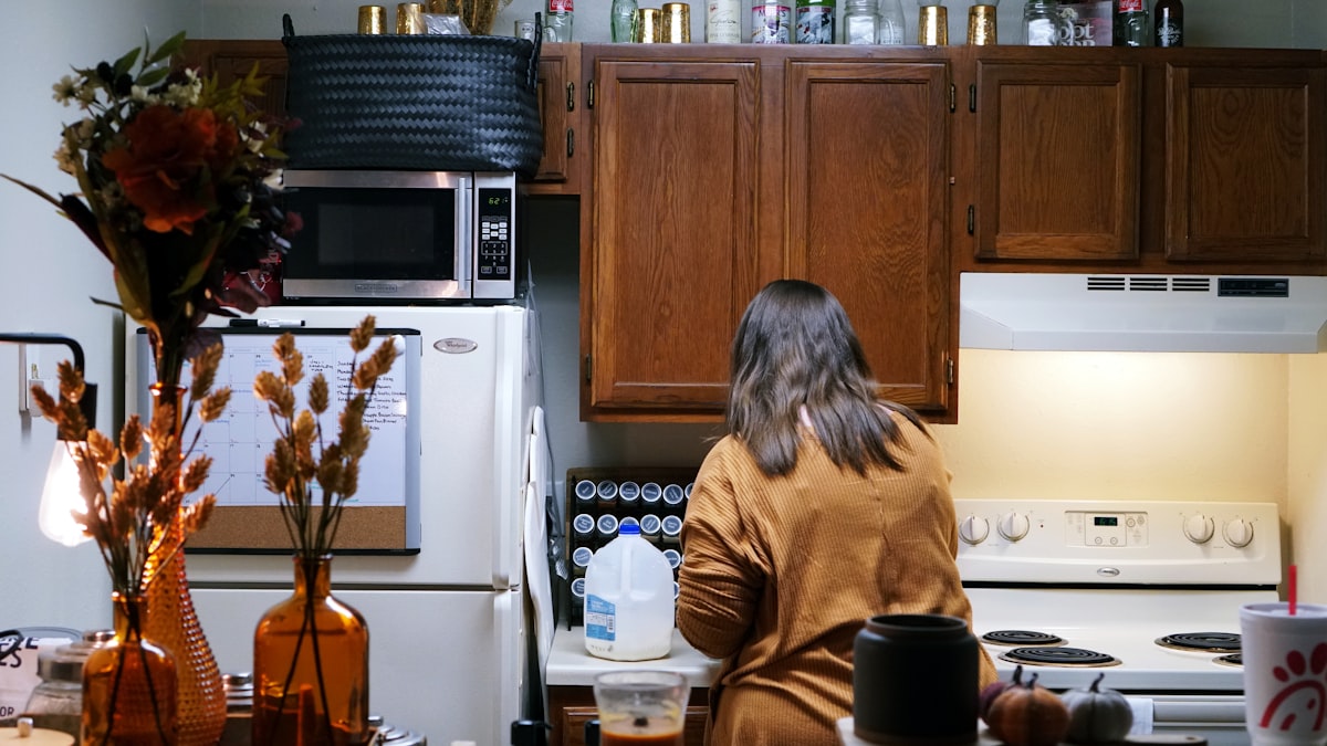 woman cooking in small apartment kitchen related to Experience Charm and Comfort: A Guide to Bed and Breakfasts in Iowa