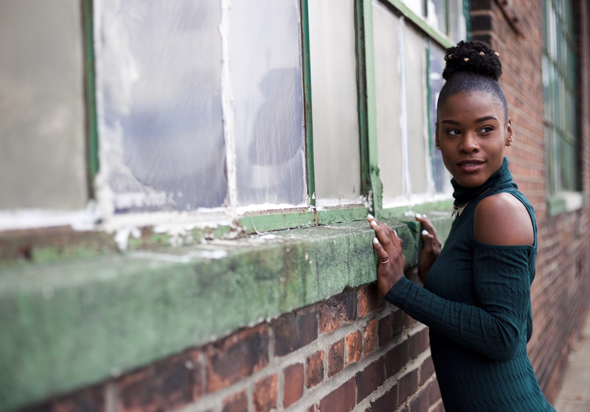 woman holding wall related to Unlock the Beauty of Your Windows: A Guide to Window Valance Boxes