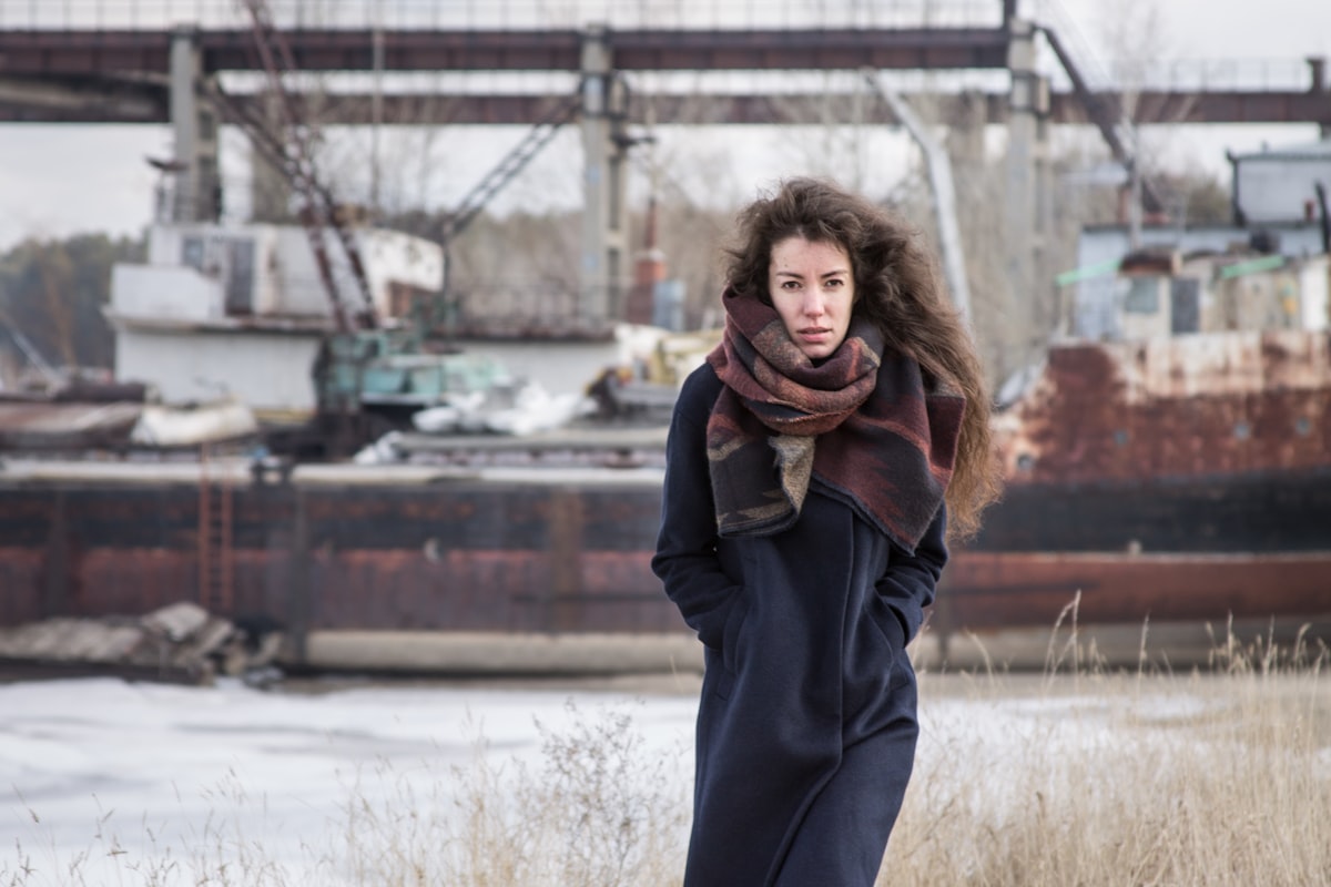 woman in black overcoat related to Navy Blue Scarf Valance: Elevated Home Decor