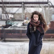 woman in black overcoat related to Navy Blue Scarf Valance: Elevated Home Decor