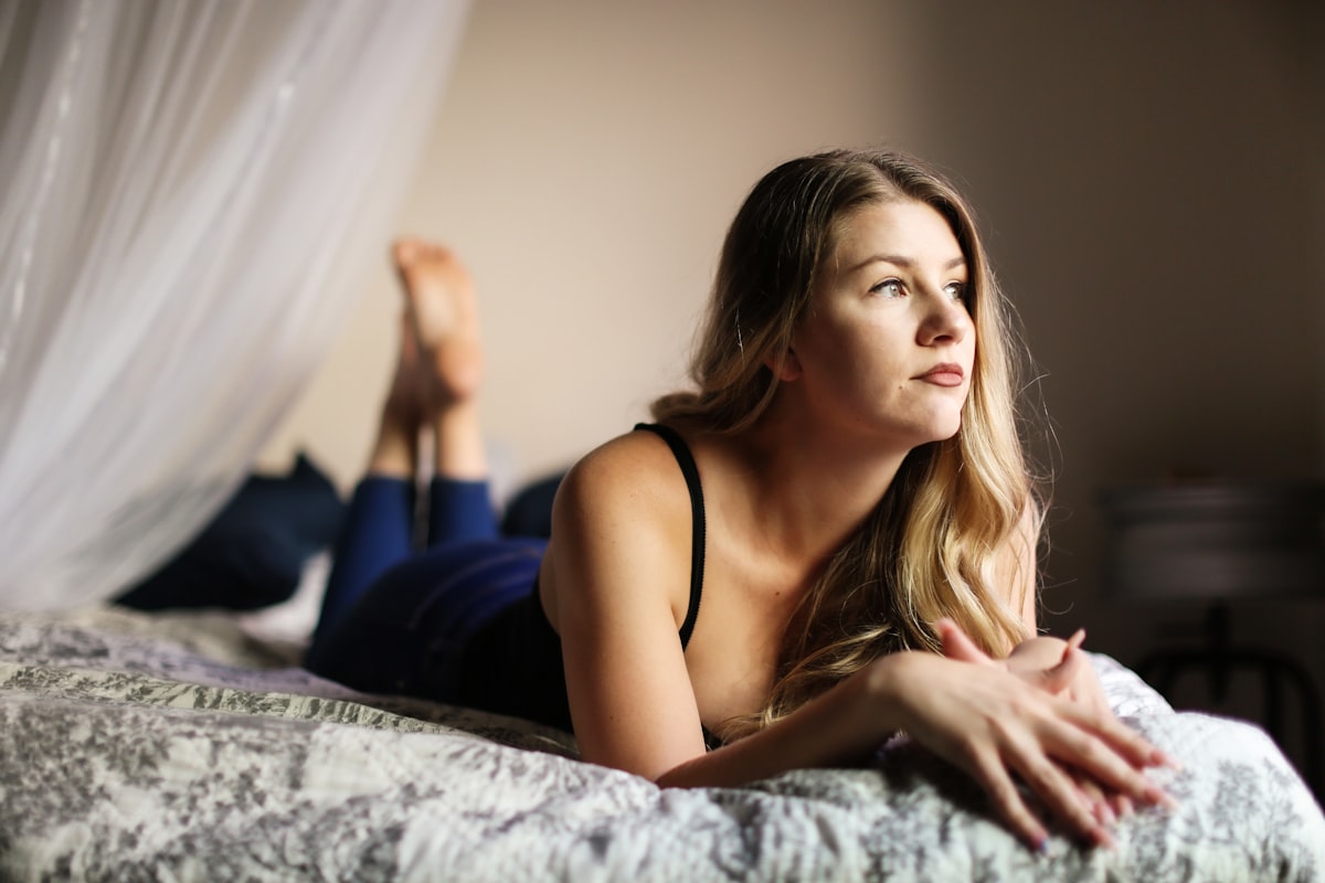 woman in black spaghetti strap top lying on bed related to Unraveling the Mysteries: What Women Like in Bed