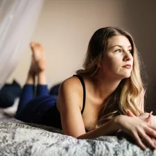 woman in black spaghetti strap top lying on bed related to Unraveling the Mysteries: What Women Like in Bed