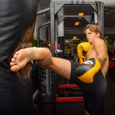woman in black tank top and black shorts doing push up related to Toe Kick Valance: The Perfect Solution for Kitchen Cabinets