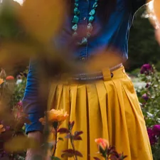 Woman in flower garden. related to Pleated Valances: Elevate Your Window Treatments