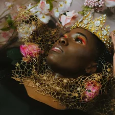 woman in gold and white floral head dress related to Luxurious Gold Coverlets for a Queen Size Bed