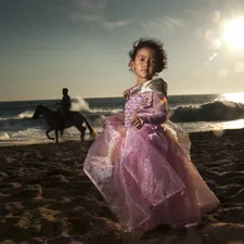 woman in purple dress standing on beach during daytime related to Magical Dreams: Princess Toddler Bed Set