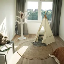 woman in white dress standing on white textile related to Cozy Nook for Little Ones: Choosing the Best Kids Bed Tent