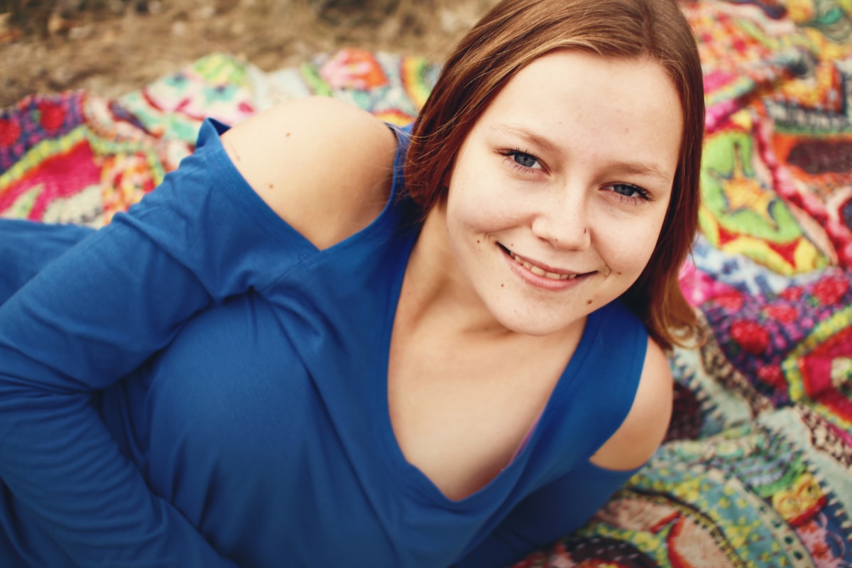 woman lying on textile related to Top Teen Bed Spreads: Trendy Choices for Every Teen's Room