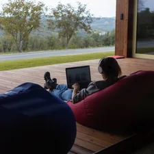 Woman remote work outdoors related to The Ultimate Guide to Bean Bag Beds