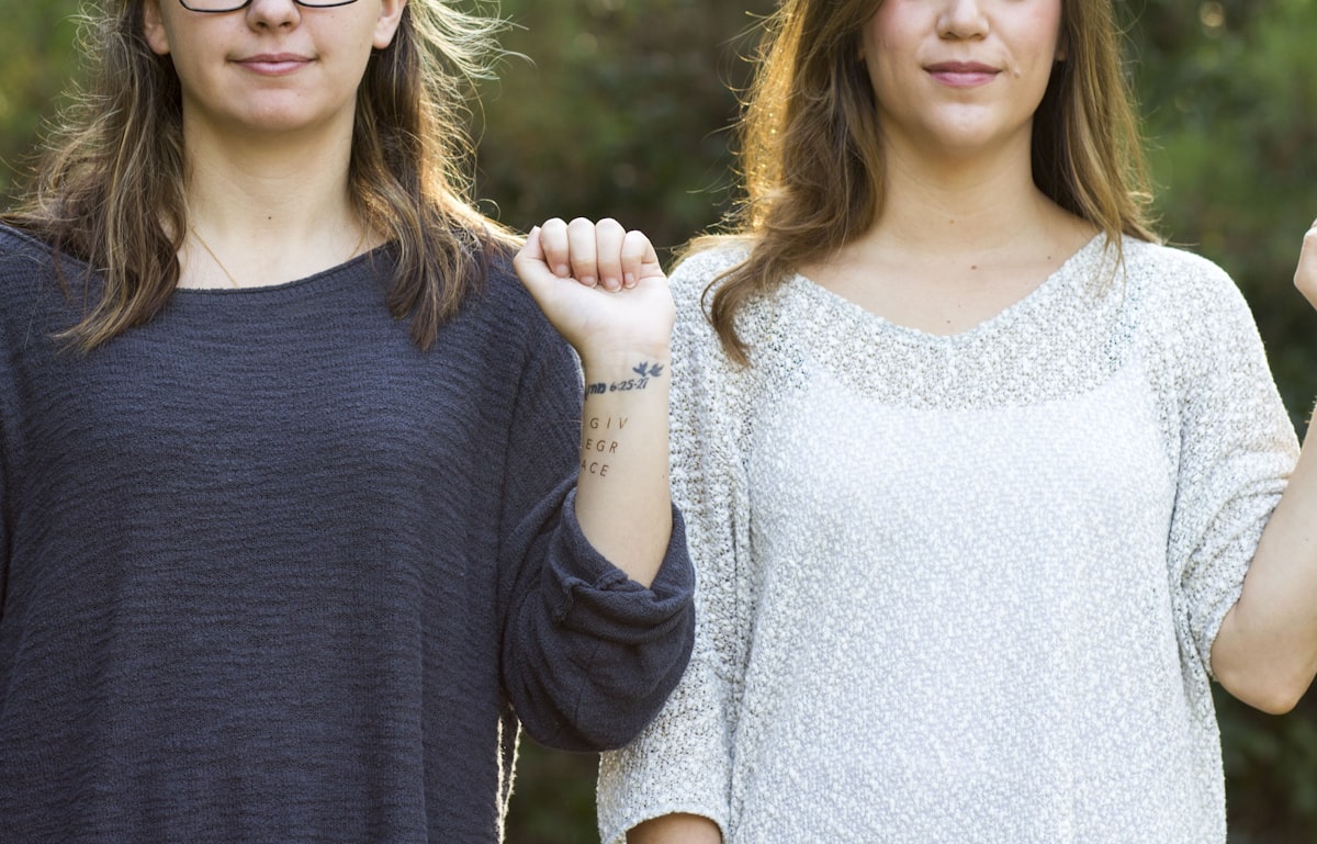 woman showing her wrist with tattoo related to What Size is a Twin Bed: A Comprehensive Guide