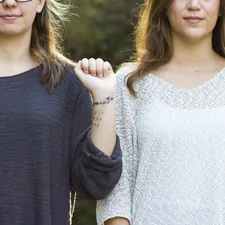 woman showing her wrist with tattoo related to What Size is a Twin Bed: A Comprehensive Guide