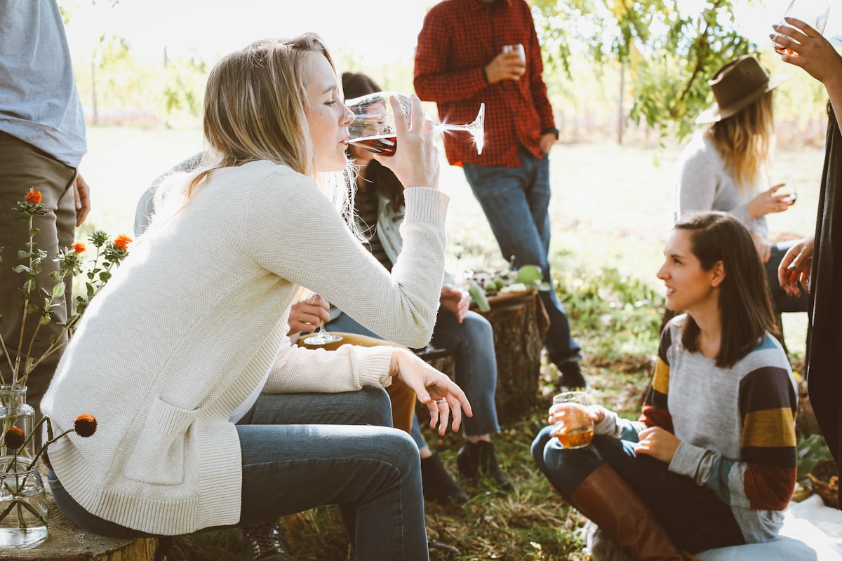 woman sitting near people while drinking related to The Ultimate Outdoor Gathering Spot: Extra Large Chiminea Cast Iron