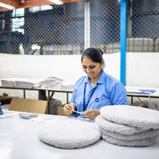 Woman sorts items at a factory workstation. related to Unleashing the Secrets of Bed Body Works: A Comprehensive Guide