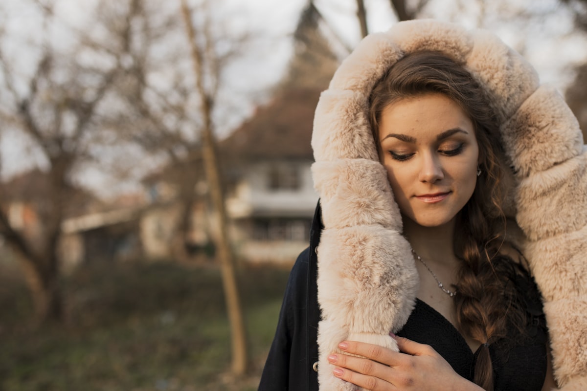 woman wearing black and white coat related to Wrap Yourself in Regal Comfort with a Grey King Coverlet