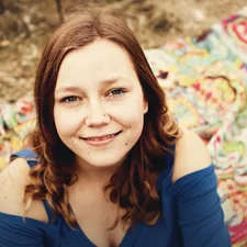 woman wearing blue shirt related to Blue Quilts and Coverlets