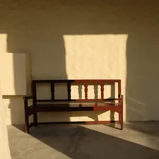 Wooden bench casting shadows on a sunny day related to Elevate Your Entryway with an Espresso Finish Bench