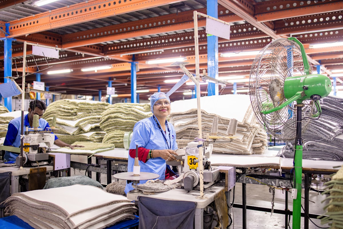 Workers sew fabric at a factory production line. related to The Rise of Natural Bed Companies: Embracing Eco-Friendly Sleep Solutions