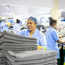Workers sort towels in a factory. related to Thriving Careers at Bed Bath & Beyond: Your Path to Success