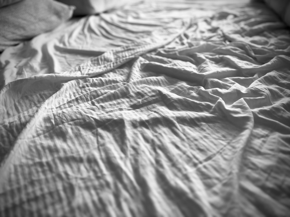 Wrinkled bed sheets look soft and inviting. related to Coverlet for Bed: Enhance Your Bedroom Aesthetic