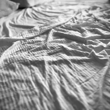 Wrinkled bed sheets look soft and inviting. related to Coverlet for Bed: Enhance Your Bedroom Aesthetic