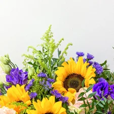 Yellow and purple flowers and greenery with negative space above. related to Brighten Your Space with Sunflower Valance Curtains