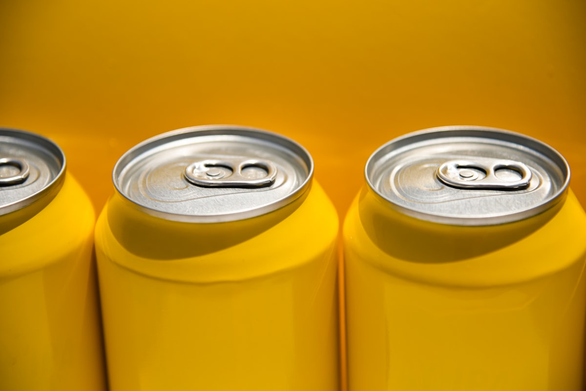 Yellow beer cans, with yellow backdrop. Outside in the California sunshine related to Add a Pop of Sunshine with Yellow Chevron Valance